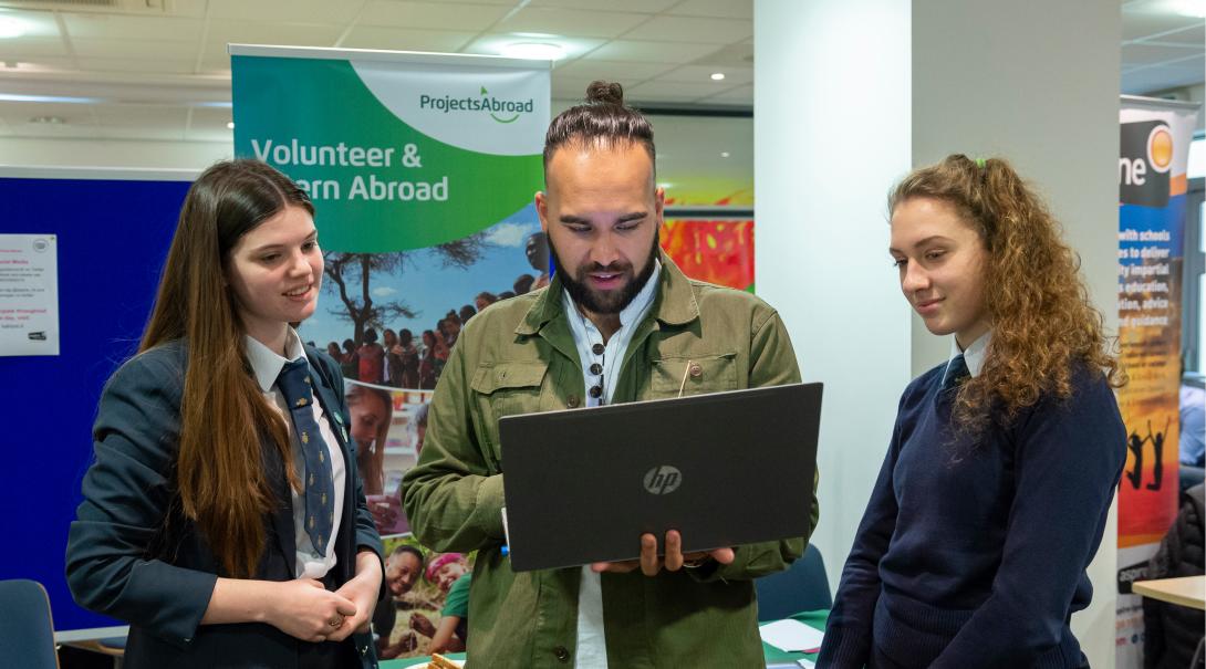 Leads have the volunteer projects and internships explained during an event. Projects Abroad staff talk to potential volunteers during an information event in the UK.